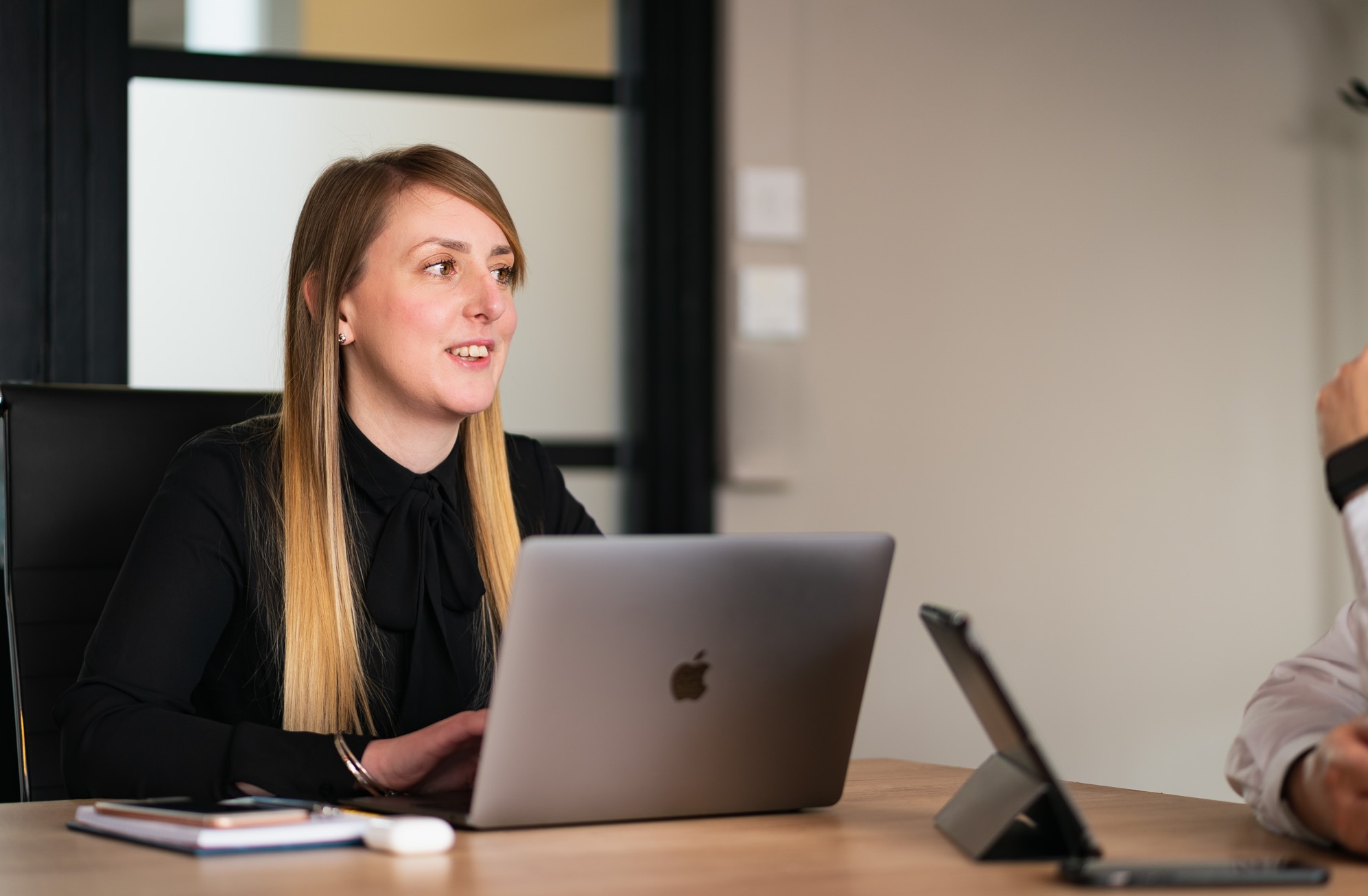 Marketing consultant reviewing automotive business performance in a meeting.