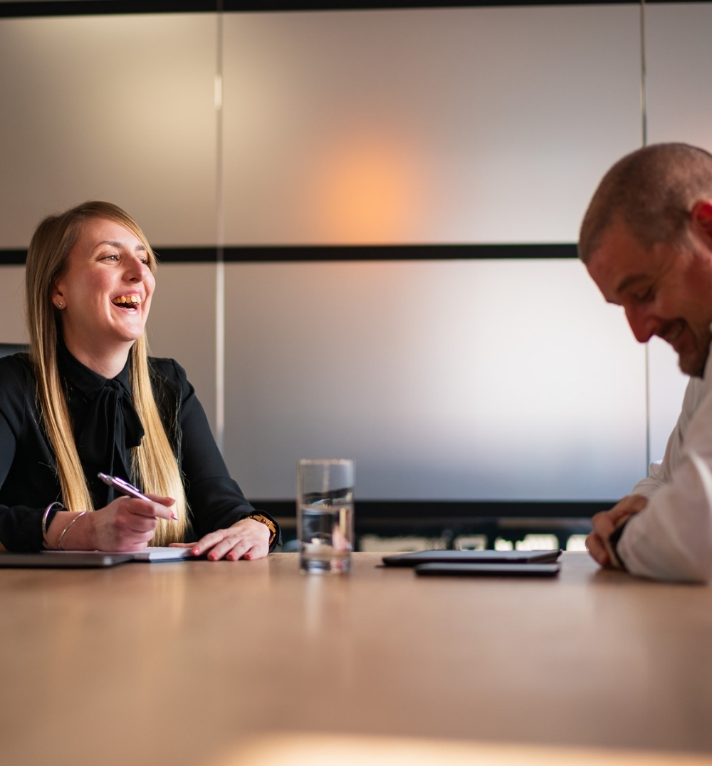 Marketing consultant mentoring an automotive professional on business growth.